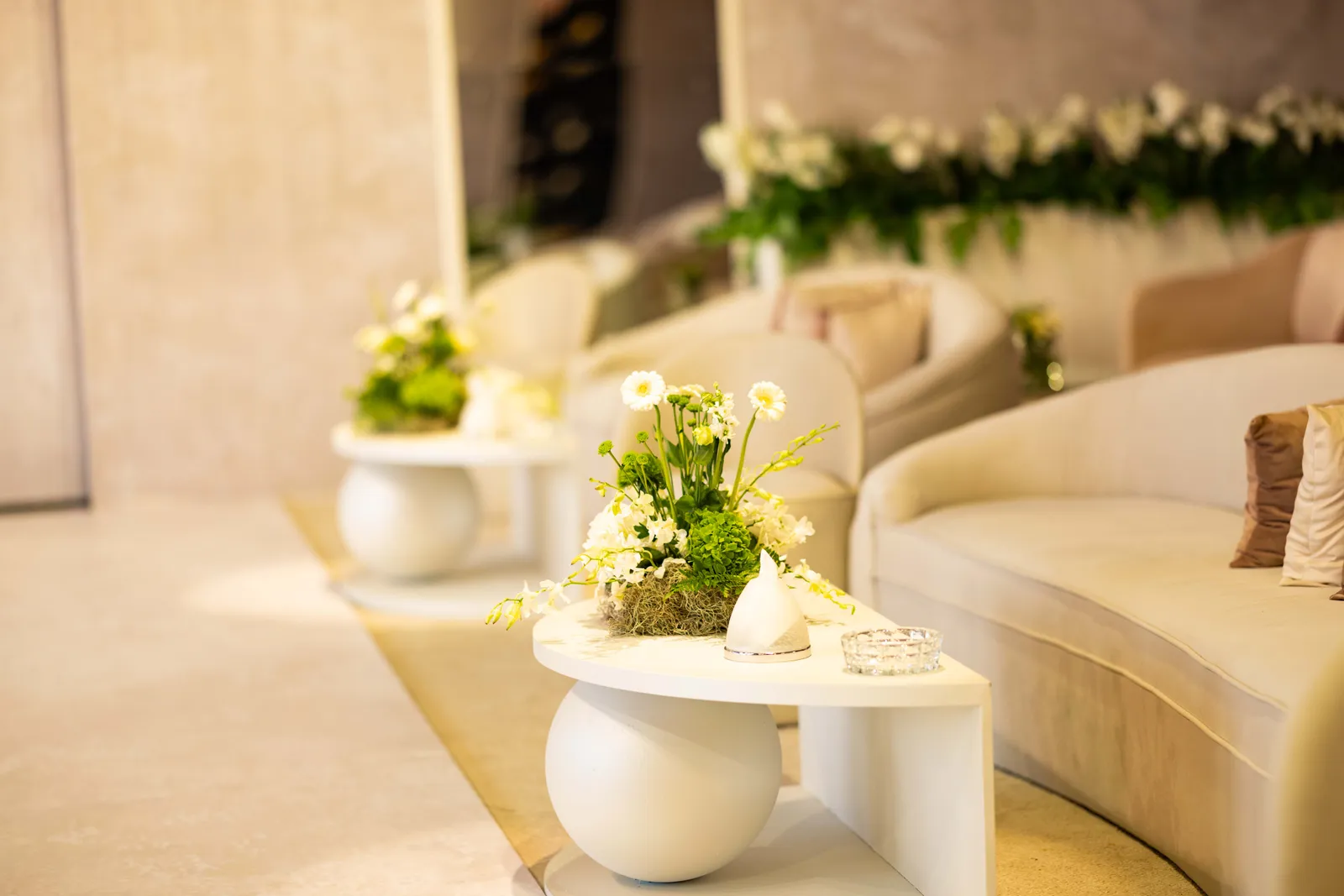 Wide ivory lounge seating styled with fresh florals
