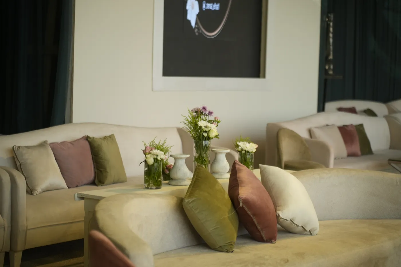Soft pink lounge seating styled for a baby-welcoming celebration
