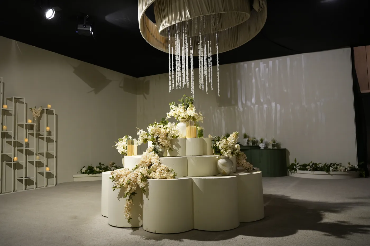 Tiered gold-trimmed wedding cake in an opulent gold-columned room